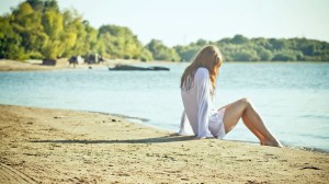 Girl Sitting Lonely On Beach